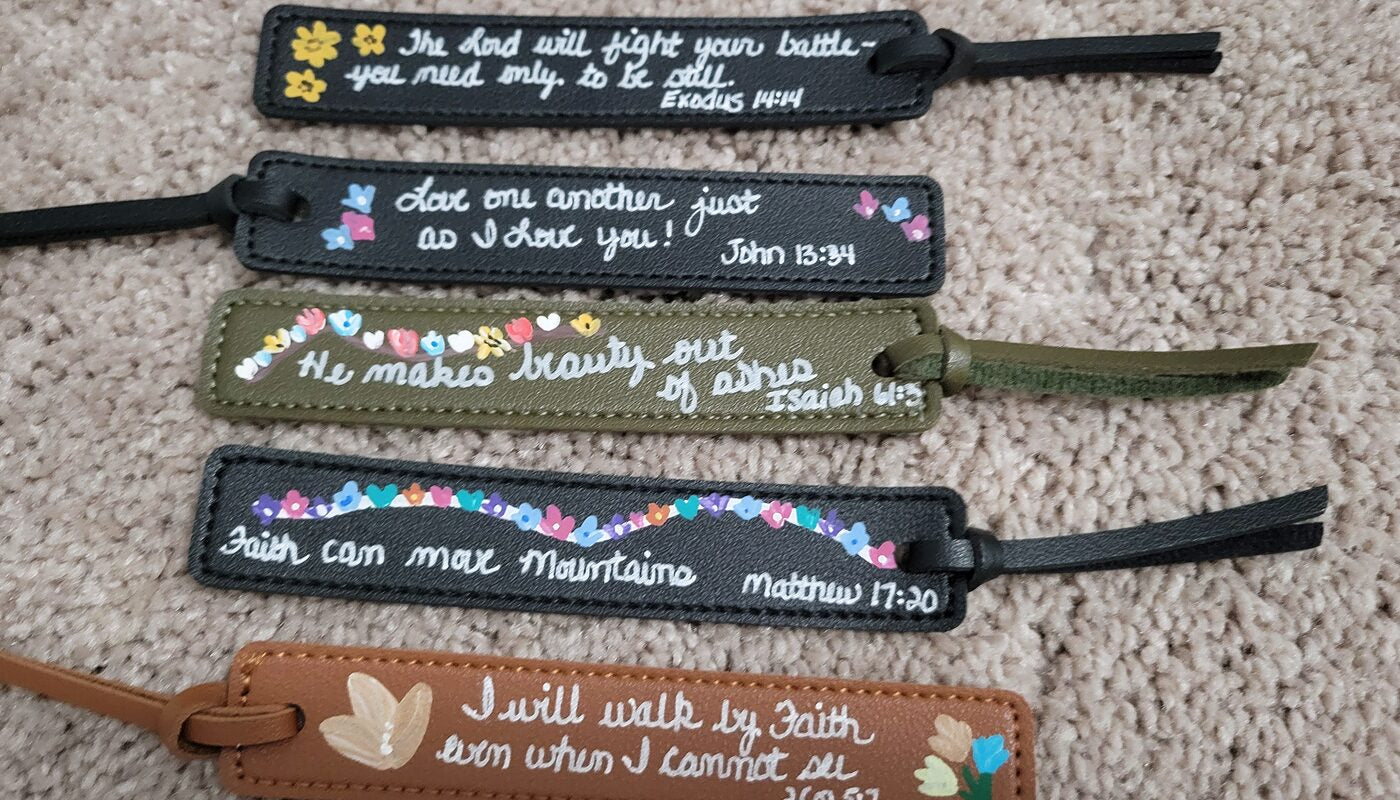 Five hand-painted leather bookmarks lettered with Scripture and painted with small flowers